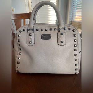 Michael Kors gray handbag with silver studs and hardware.